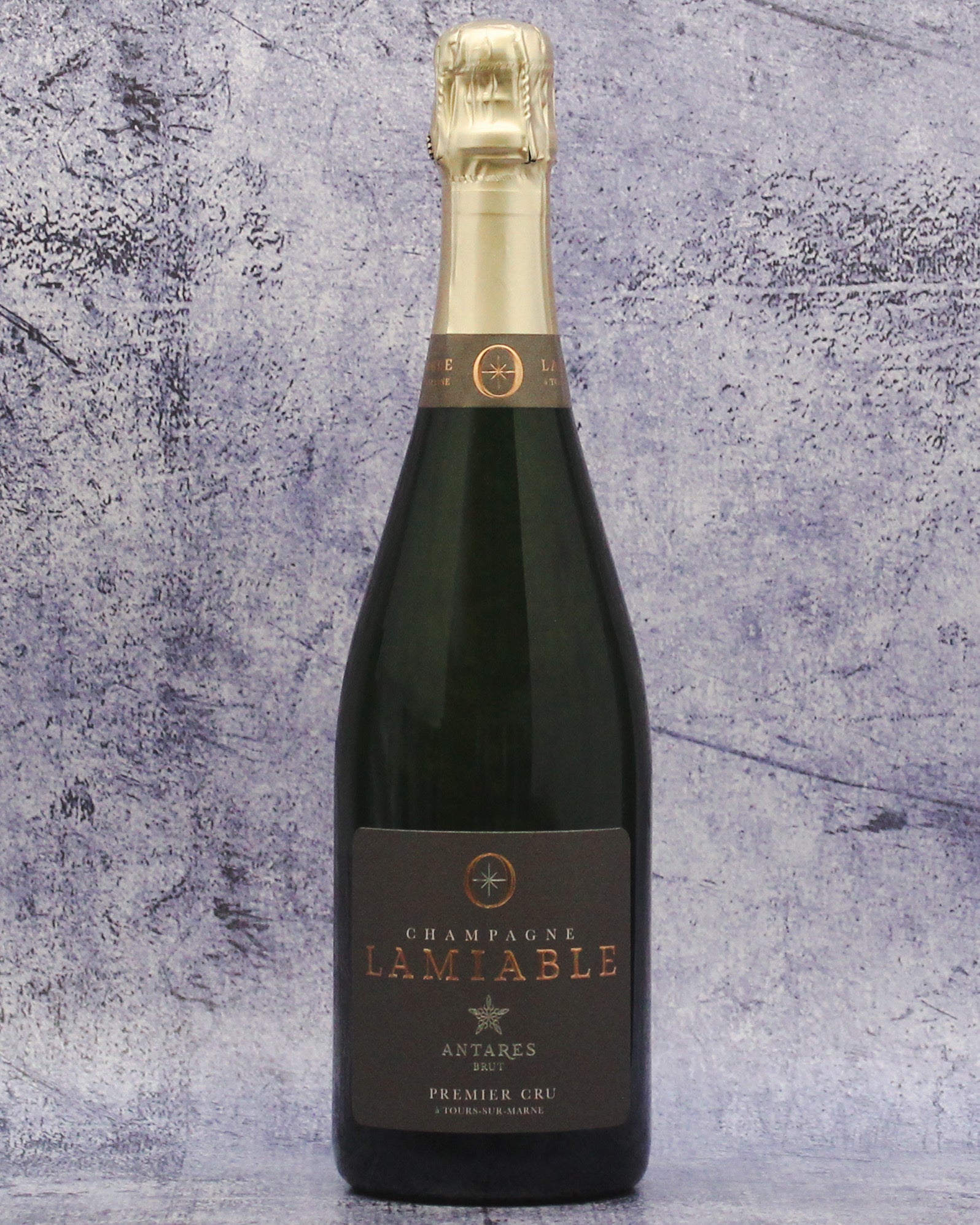 Bottle of Champagne Lamiable against a textured gray background