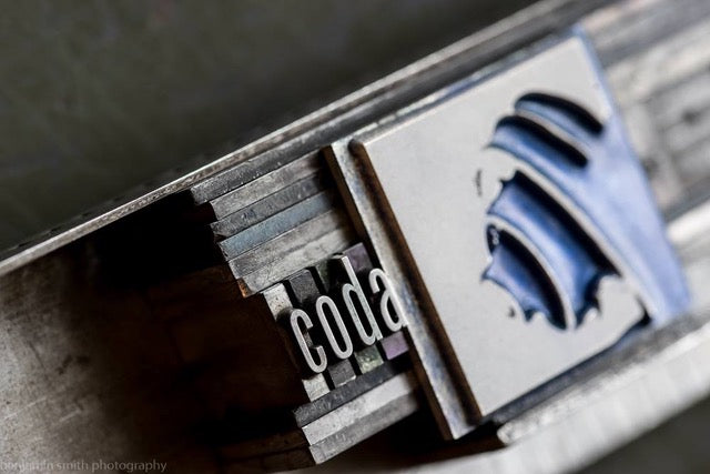  “The Coda label image is four pieces of hand-set movable lead typeset in a two-line printers bar ready for inking and printing. When printed with sufficient pressure, this type creates a beautiful letterpress emboss that is the epitome of the printer’s art.” –Ben Smith